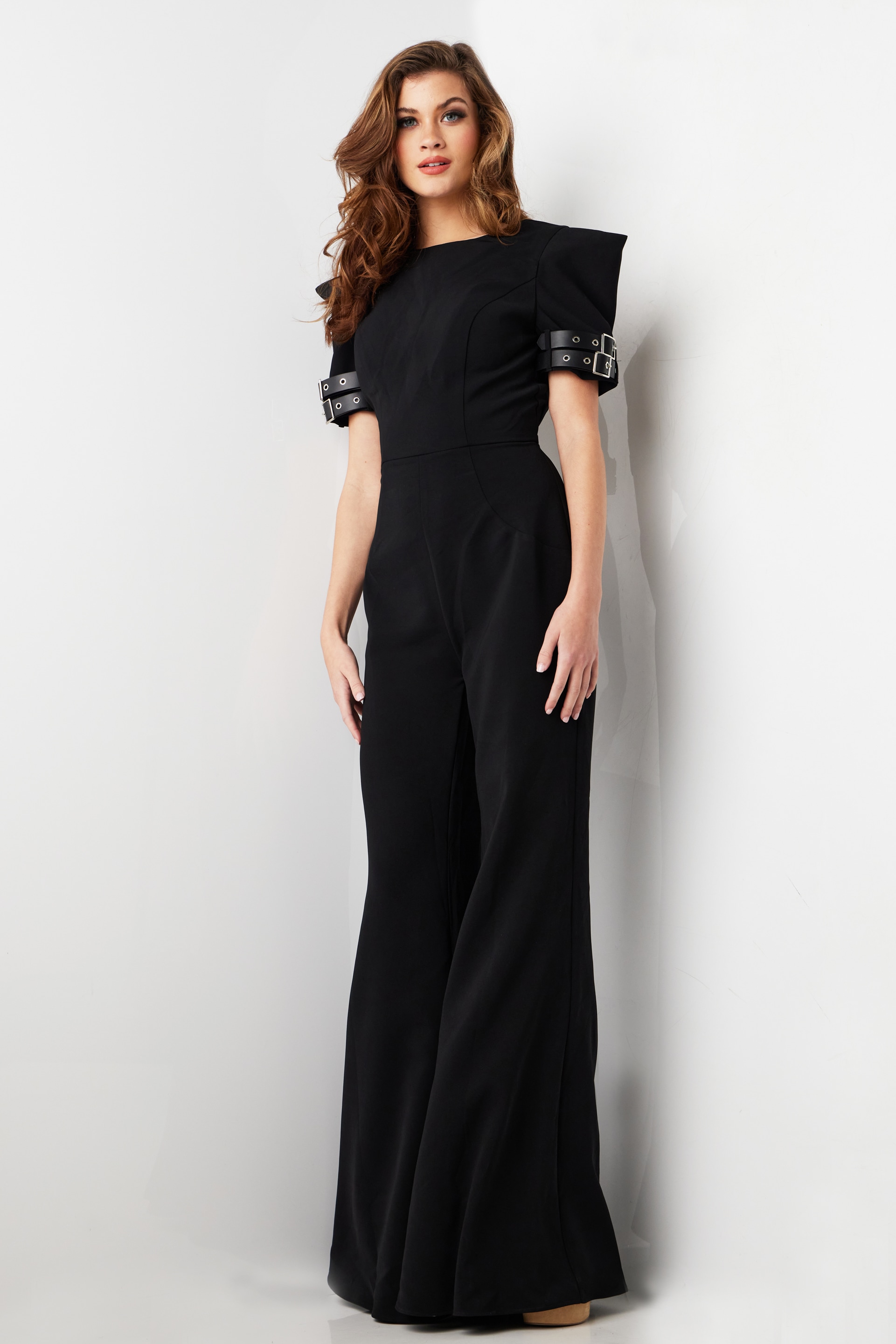 model demonstrating Jovani 36692 stylish black jumpsuit with buckle detail