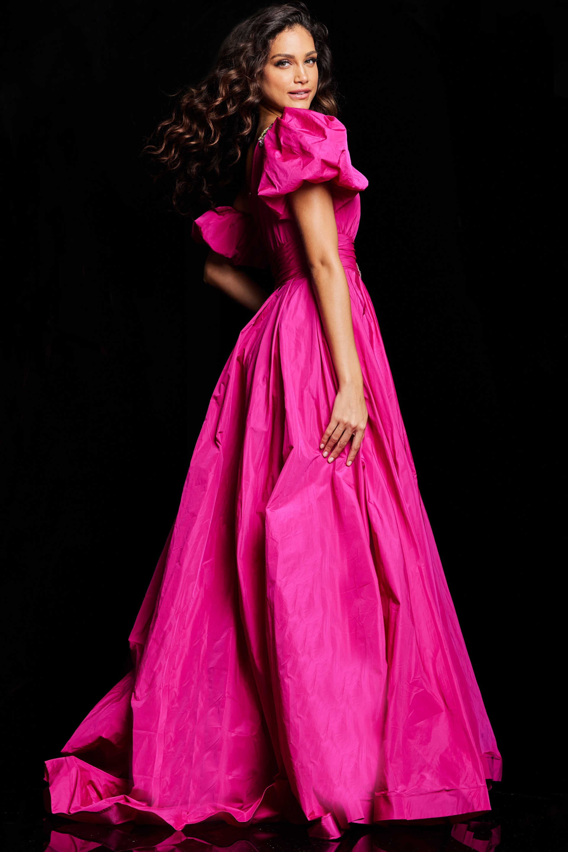 Model wearing Jovani 36872 fuchsia gown, showcasing back view with voluminous skirt.