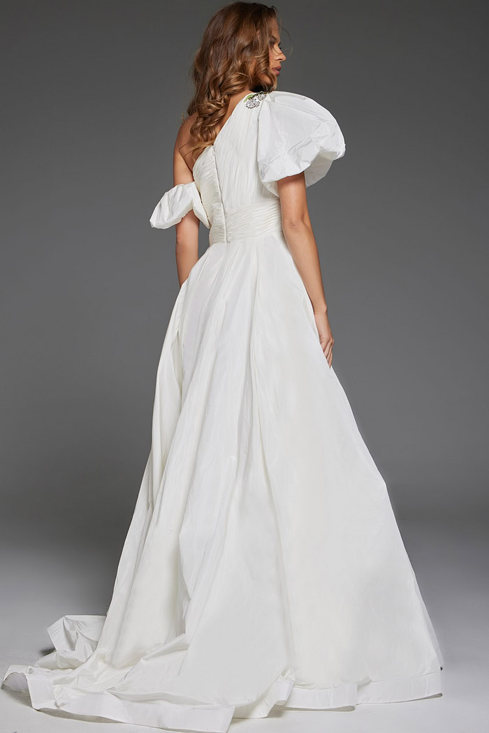 model wearing Jovani 36872 white one-shoulder gown with floral embellishments and high slit