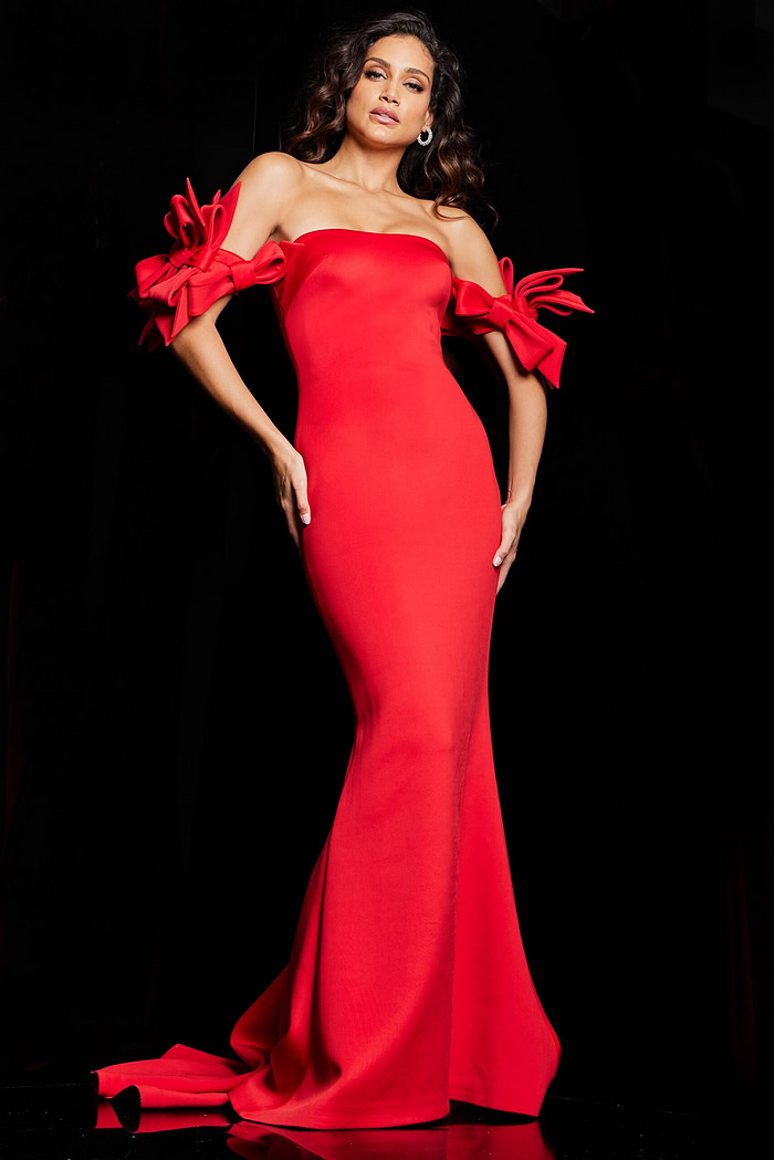 Model wearing Jovani 36997 red mermaid gown with off-the-shoulder neckline and bow details.