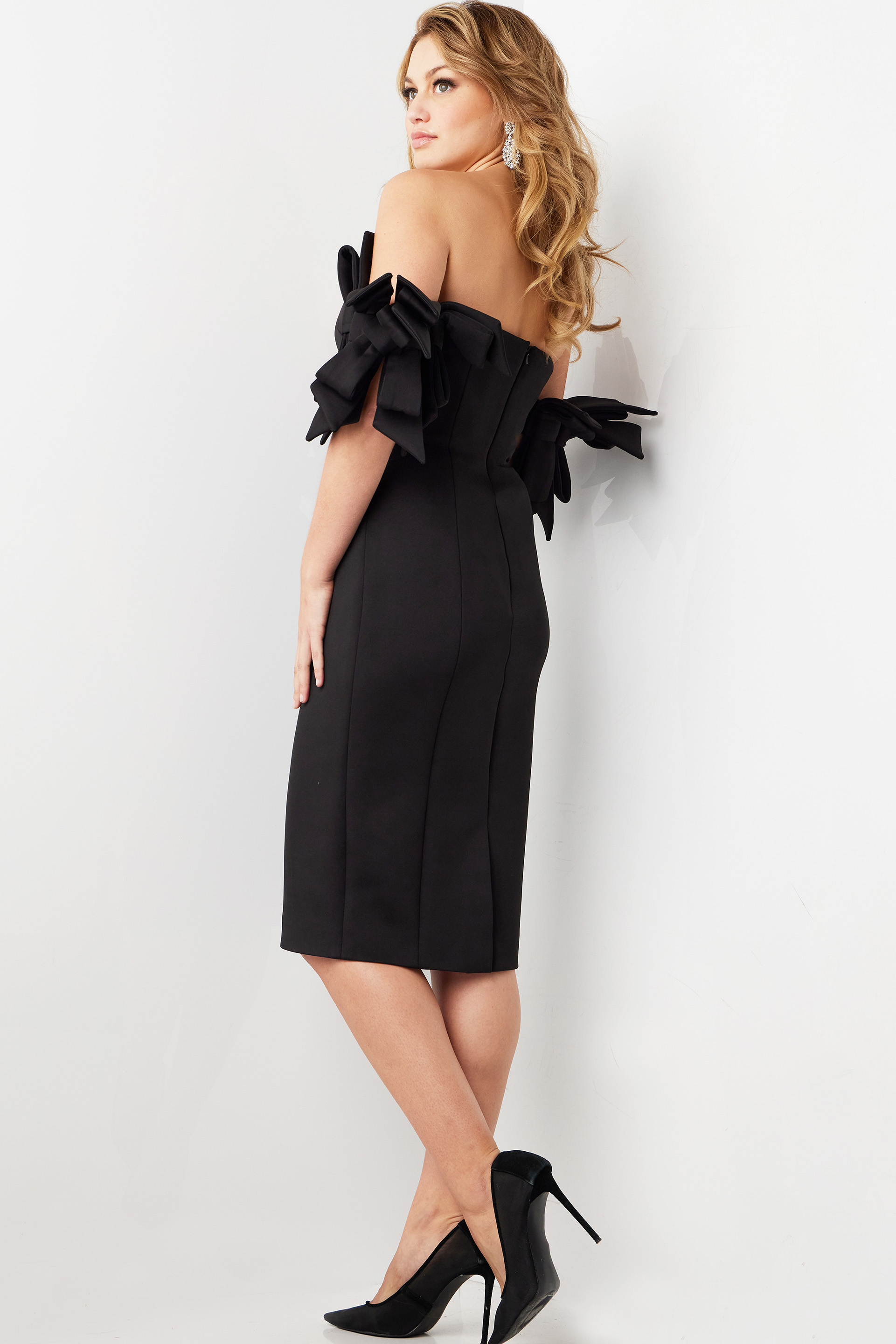 Back view of model wearing Jovani 36998 black midi dress showing the sleek silhouette.