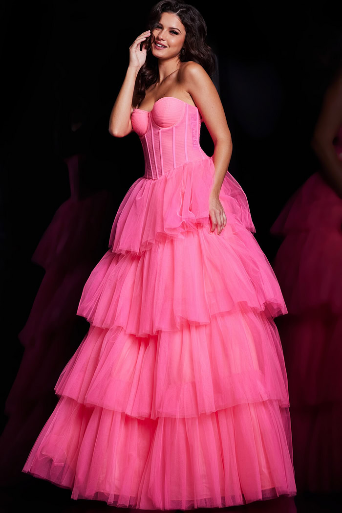 Model showcasing Jovani 37062 pink gown with corset bodice and layered skirt, front view.