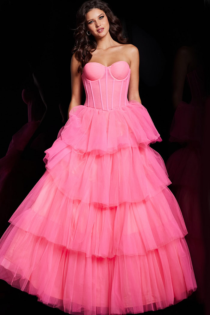 Model wearing Jovani 37062 pink gown with strapless neckline and tiered skirt, front view.