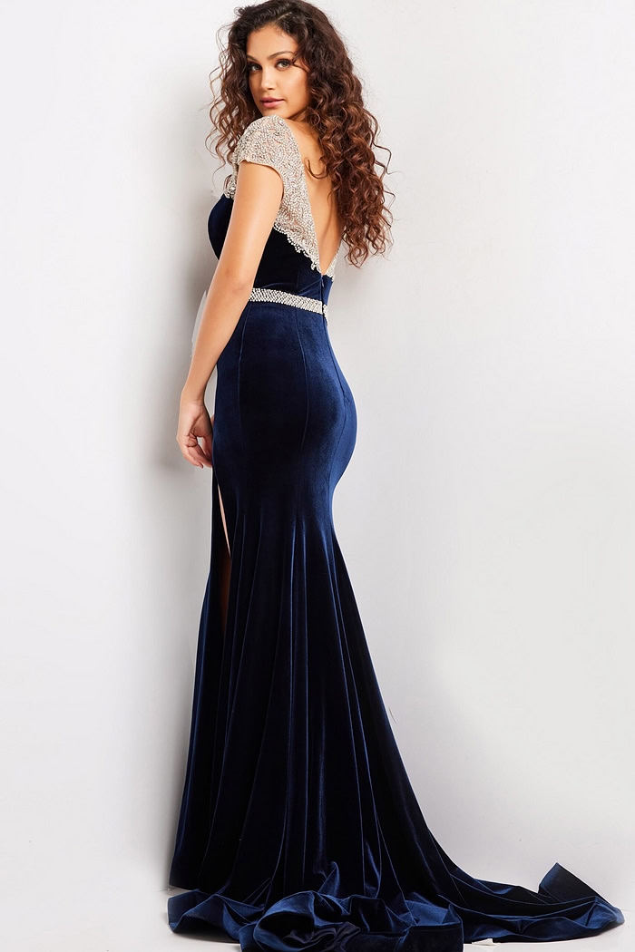 Back view of Jovani 37246 navy gown featuring a low-cut and flowing velvet skirt.