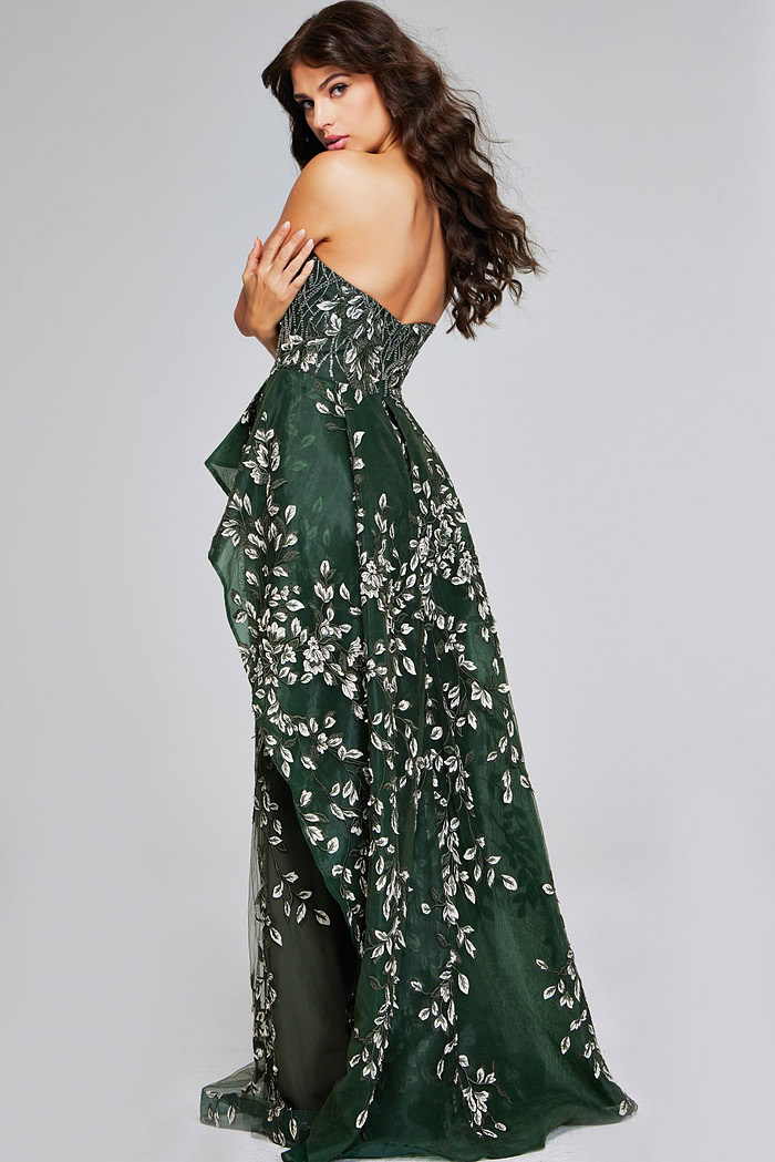 Model wearing Jovani 37599 dark green dress, back view showing the train and design.