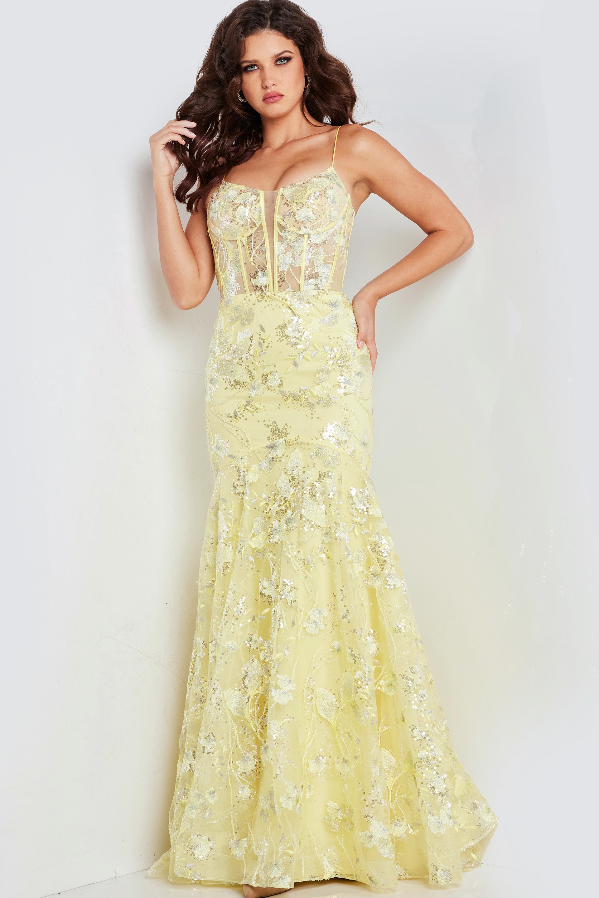 Model in Jovani 38004 yellow dress, highlighting exquisite floral embellishments.