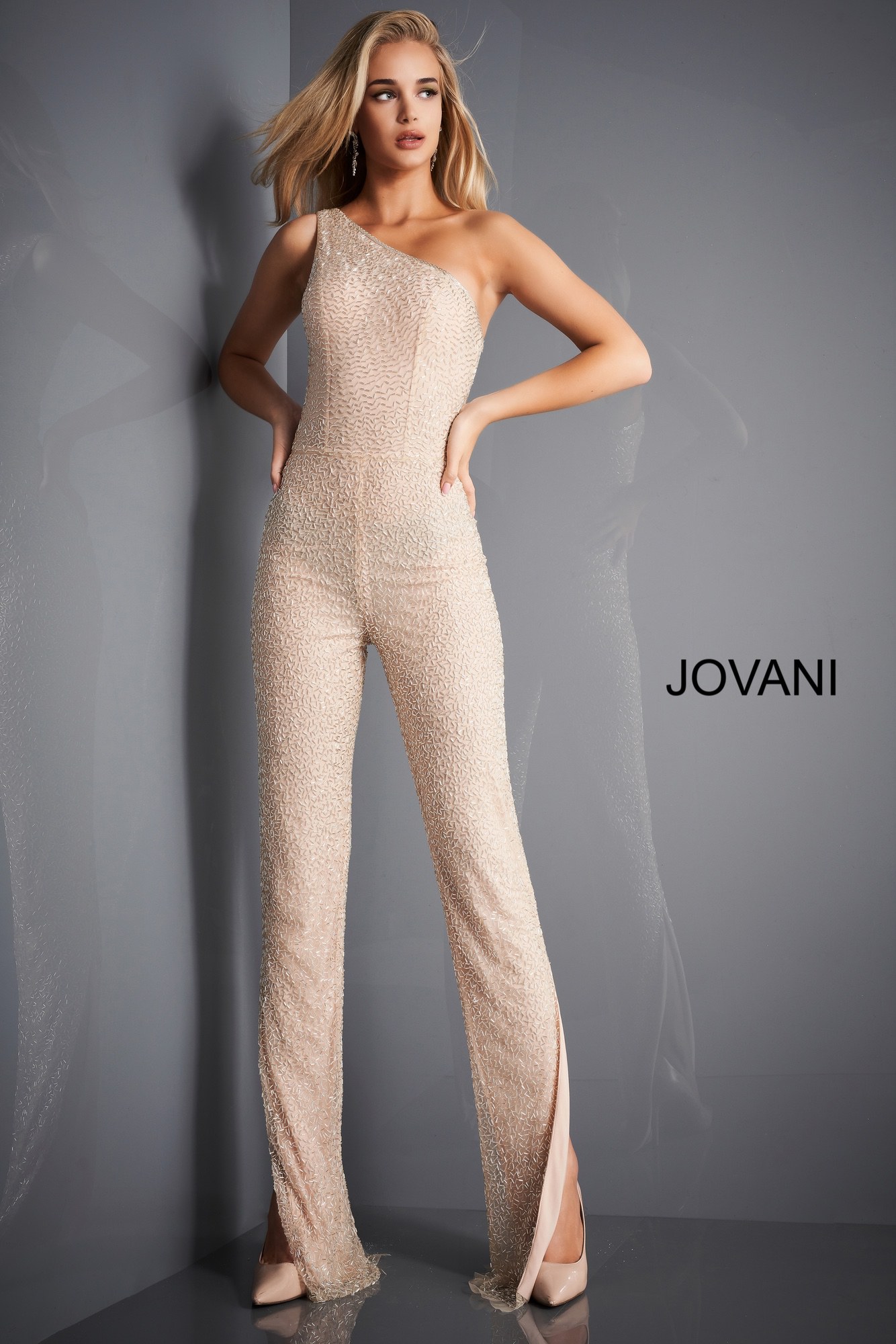 Model wearing Jovani 3816 nude jumpsuit with one-shoulder design