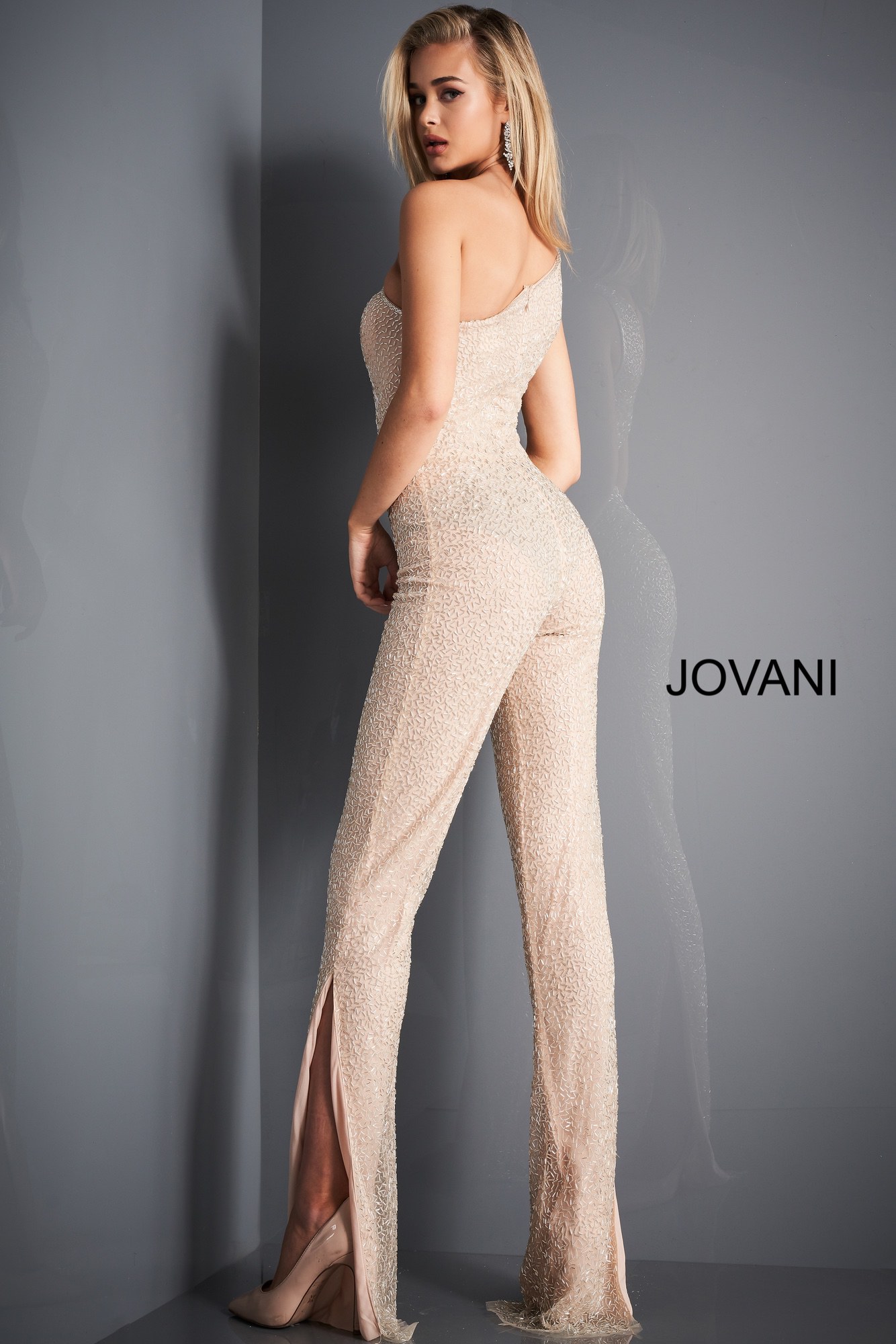 Model wearing Jovani 3816 nude jumpsuit with fitted silhouette from the back