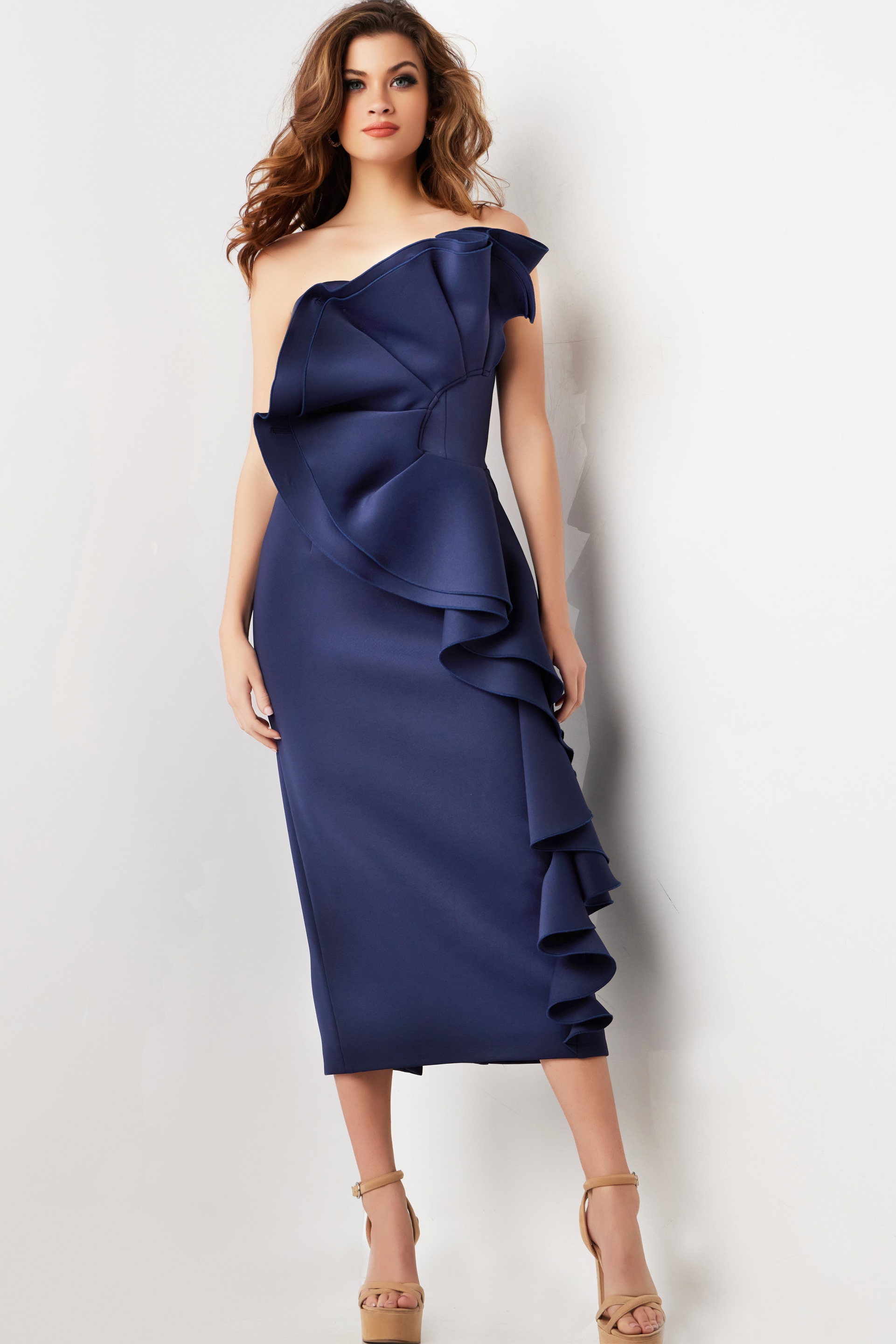 Model wearing Jovani 38187 navy dress from the front, highlighting off-the-shoulder style and dramatic ruffles.