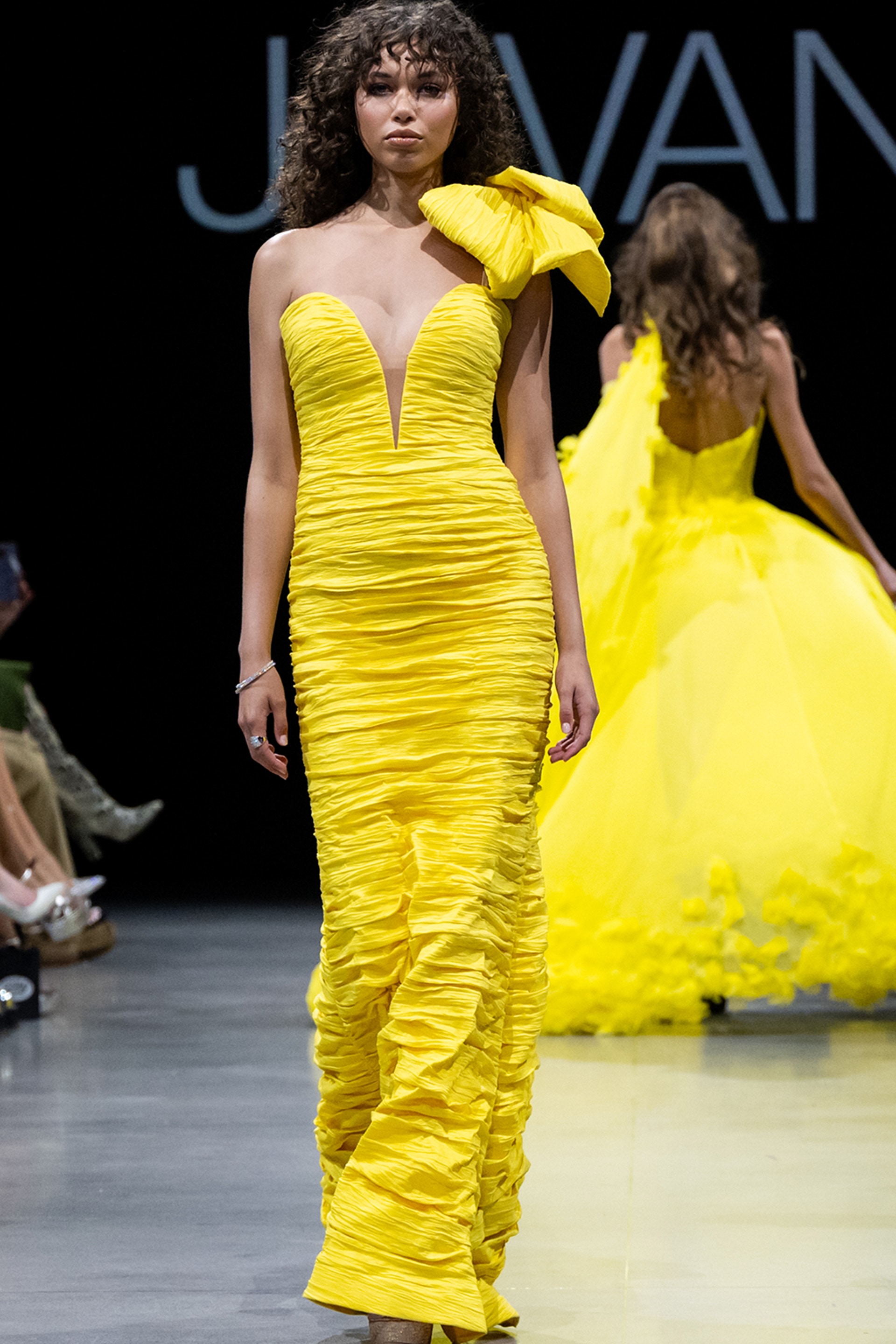 Model wearing Jovani 38240 dress with one-shoulder neckline and mermaid silhouette in yellow.