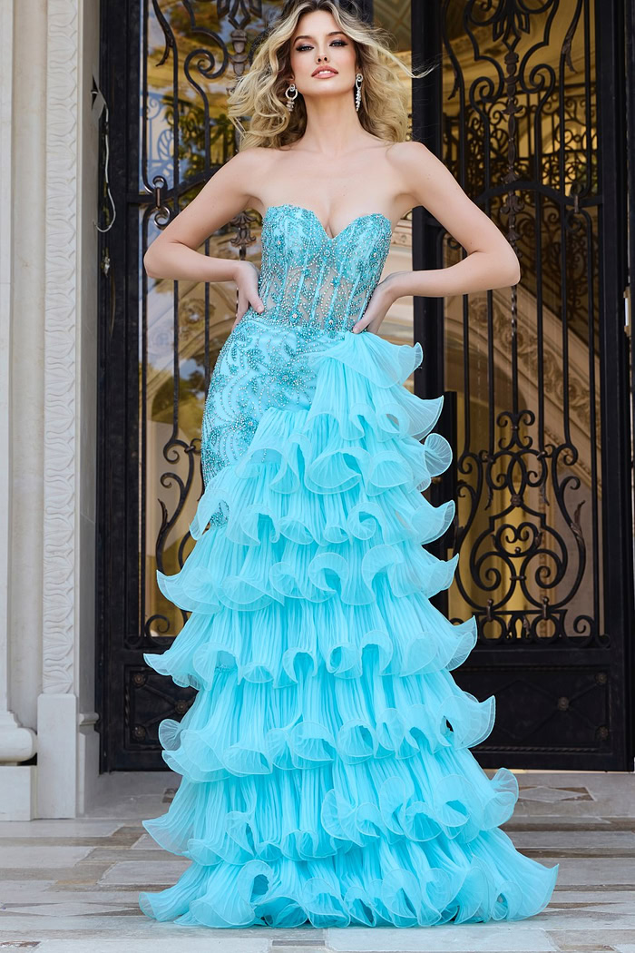 Model in Jovani 38295 blue gown, showcasing front details and beaded design.