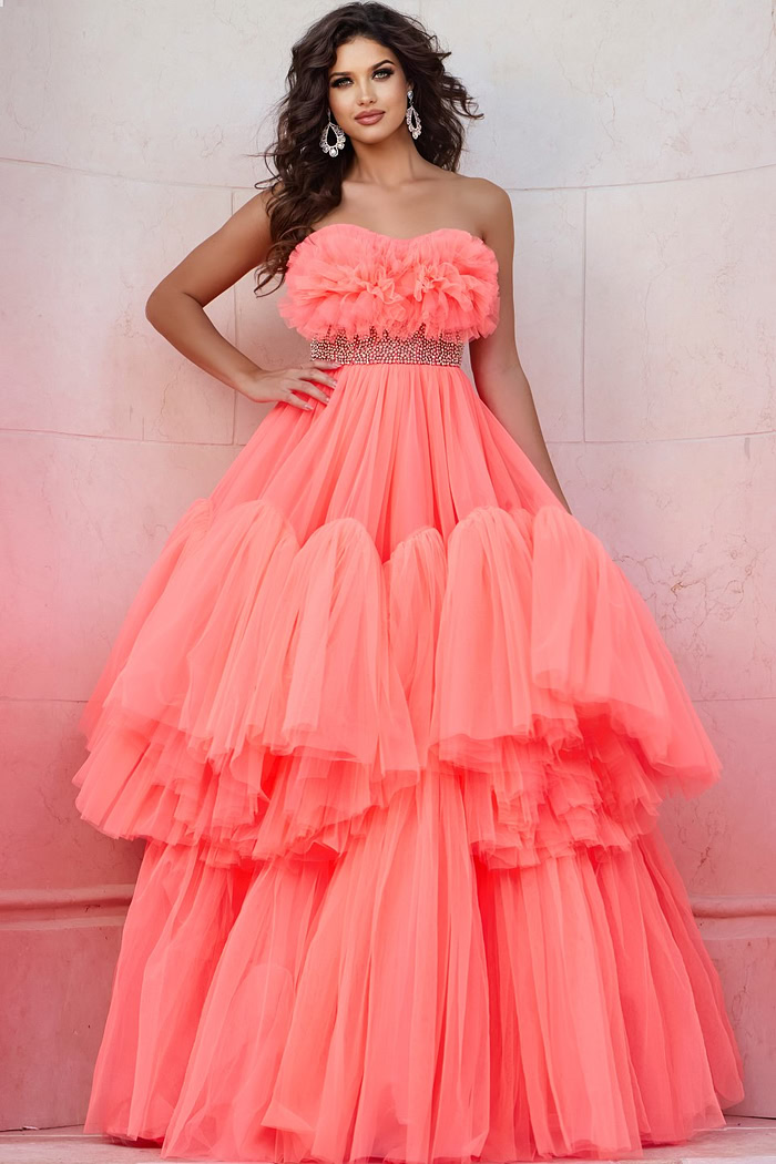 Model wearing Jovani 38299 orange gown with floral ruffles and embellished waist, front view.