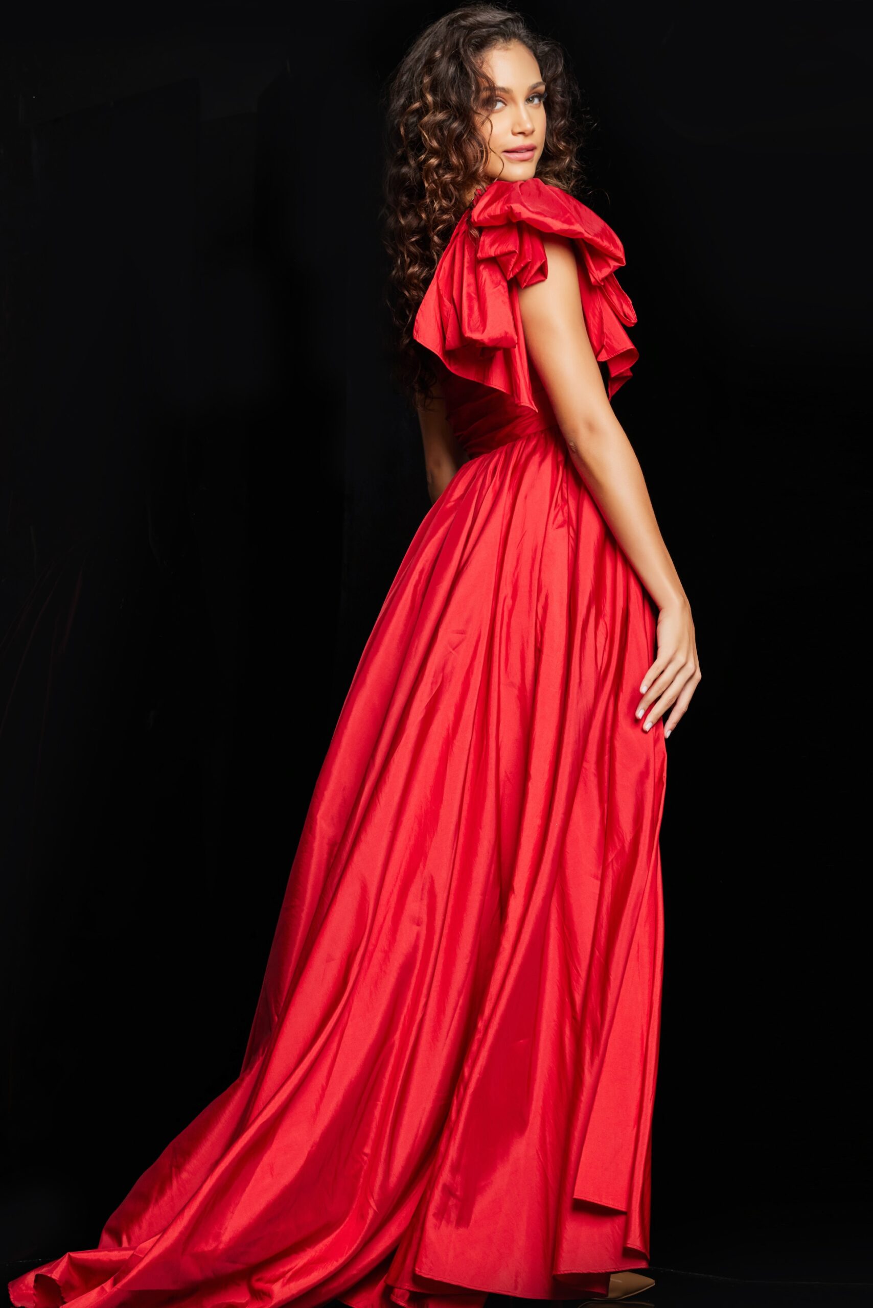 Back view of model in Jovani 38466 red gown, showcasing the one-shoulder ruffle design.
