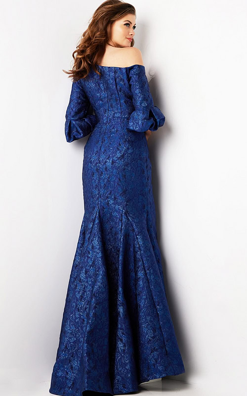 Model showing back view of Jovani 38791 navy mermaid gown with off-the-shoulder design.