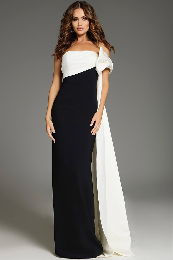 Model wearing Jovani 38864 chic black and white gown with unique shoulder drape