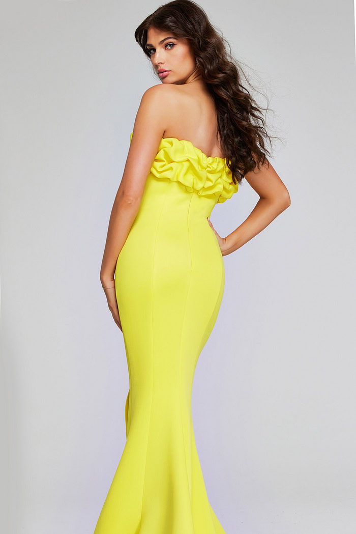 Model wearing Jovani 38922 in yellow, back view, showing the dress's full mermaid silhouette.