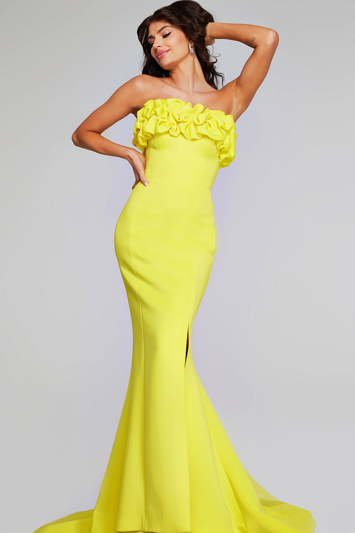Model wearing Jovani 38922 in yellow, front view with ruffled neckline.