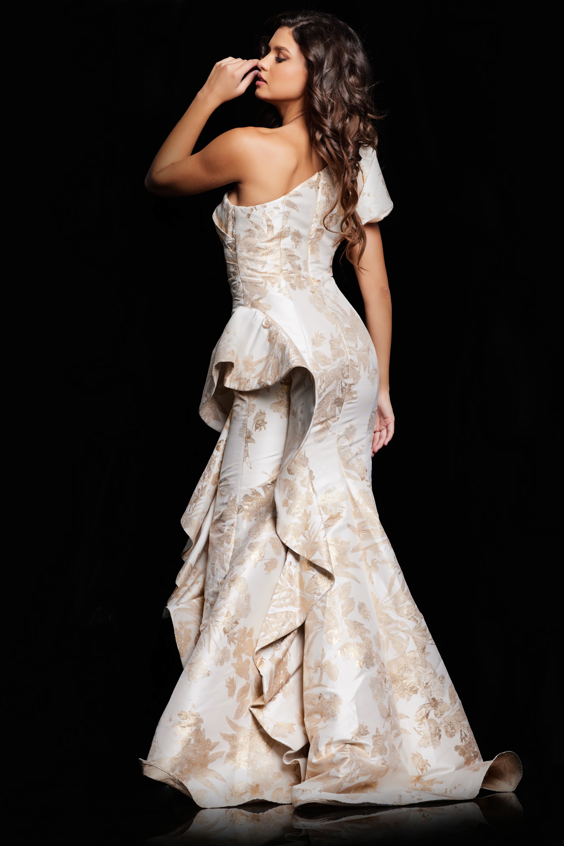 model wearing 38935 back view gold evening gown with ruffle details
