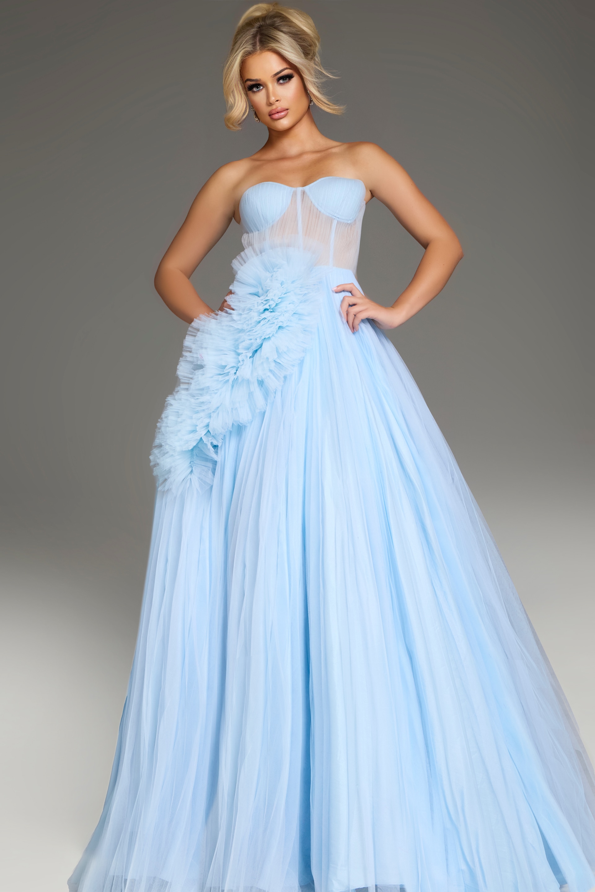 Model wearing Jovani 38946 black gown, front view displaying the unique side draping.