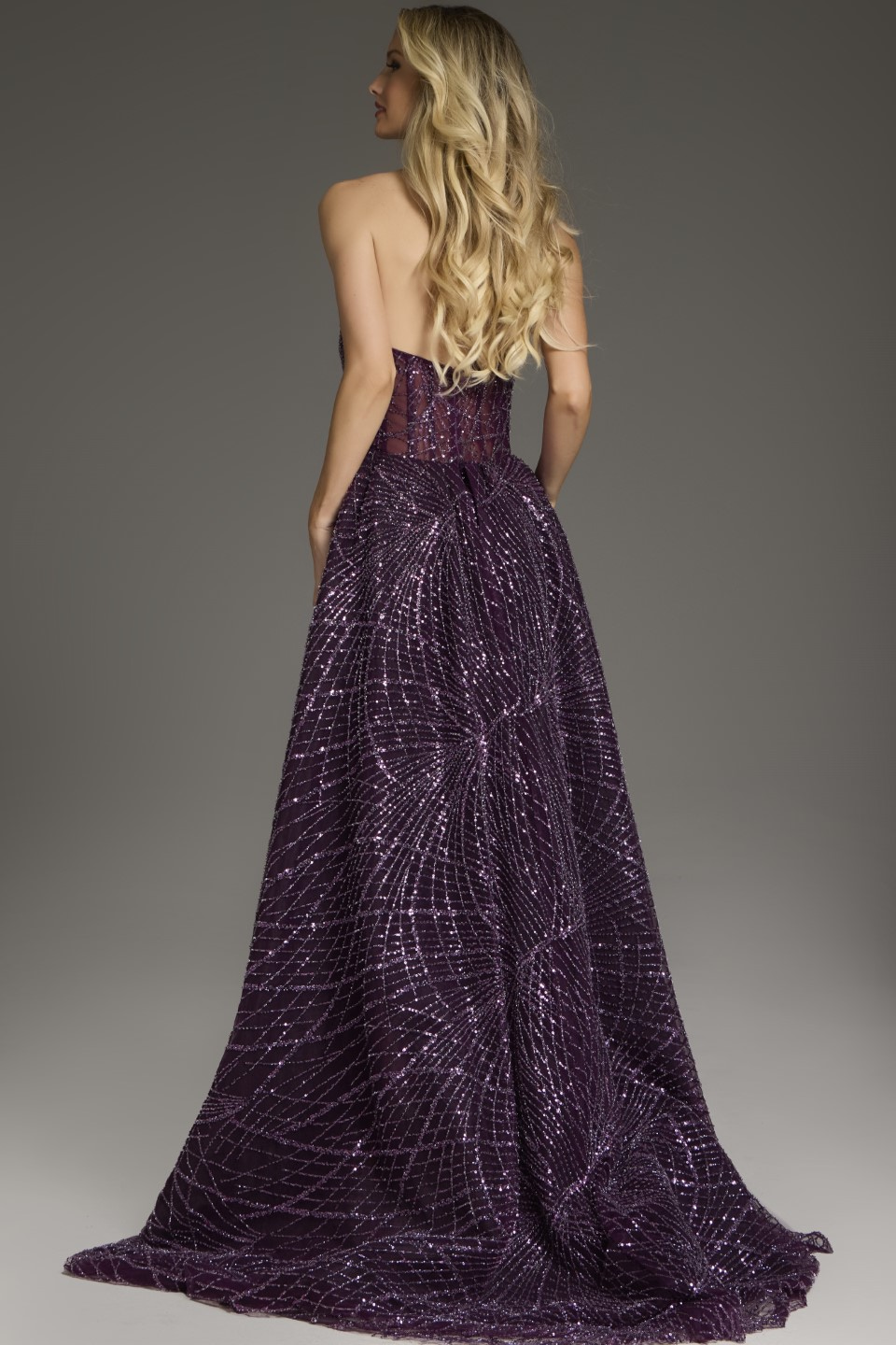 Model showing the back of Jovani 39029 purple gown with sequins, back view.