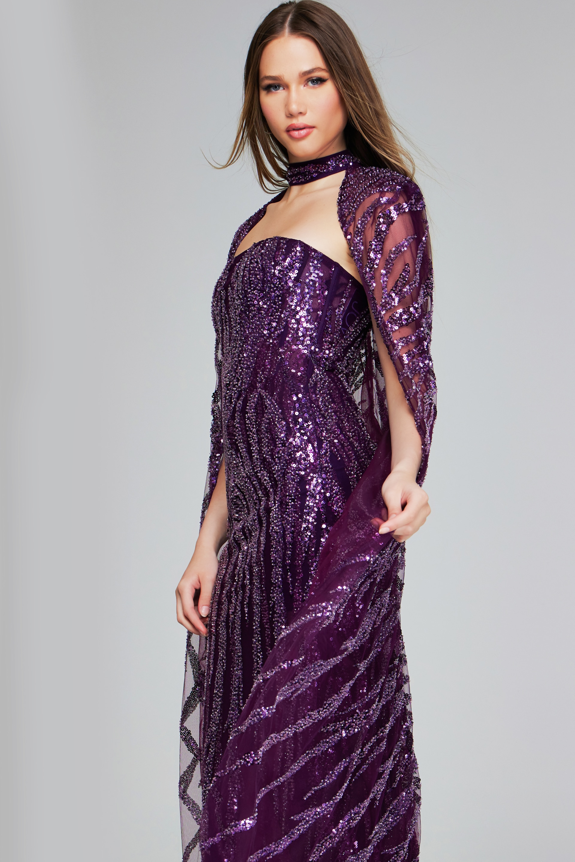 Side front view of model in Jovani 39046 purple sequin gown with off-the-shoulder neckline.