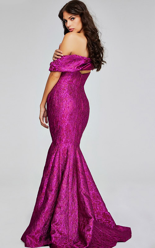 Side-back view of model in Jovani 39114 fuchsia gown.