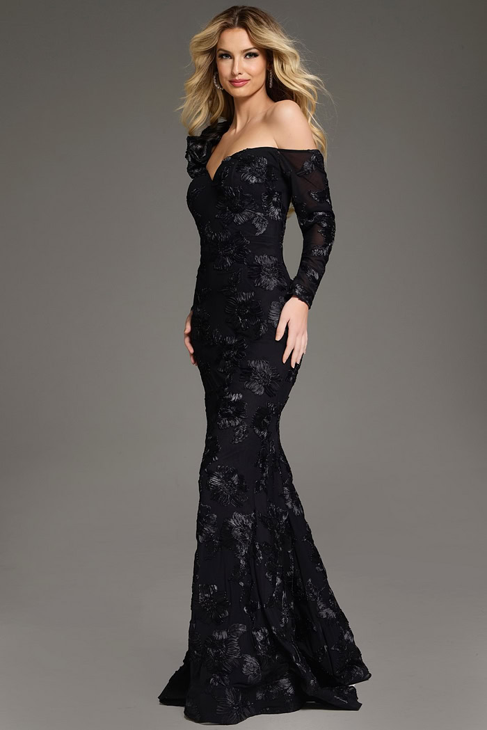 Model presenting Jovani 39266 black gown with elegant floral accents and long single sleeve.