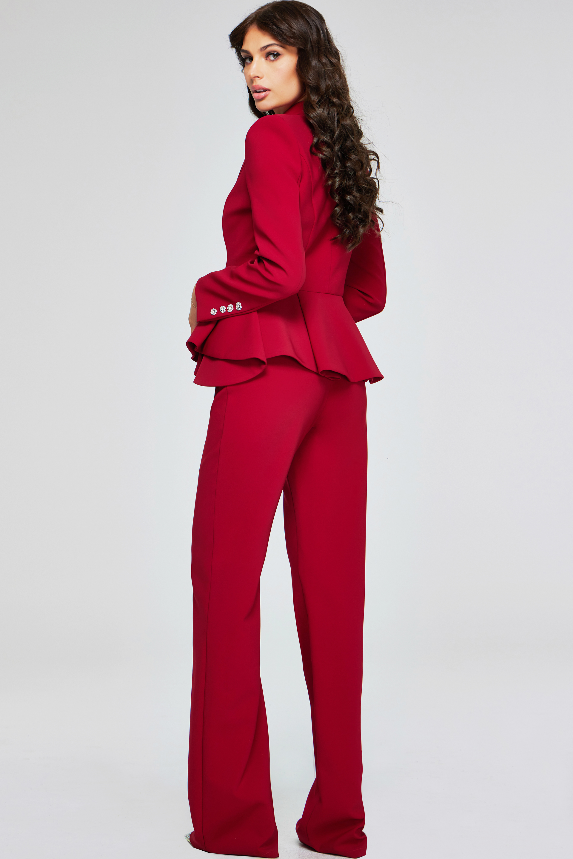 model wearing 39374 red two-piece suit, back view showcasing peplum detail