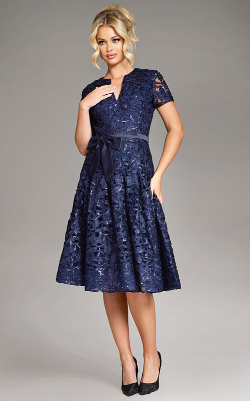 model wearing Jovani 39427 navy dress with hand on waist