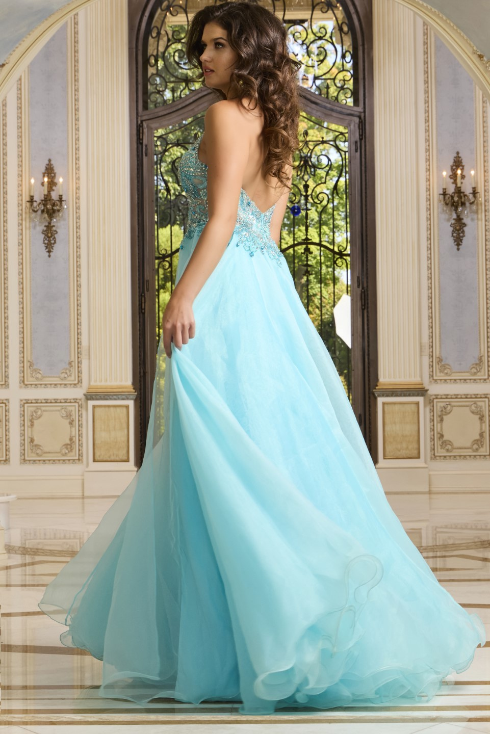 Back view of Jovani 39642, featuring an open back blue gown.
