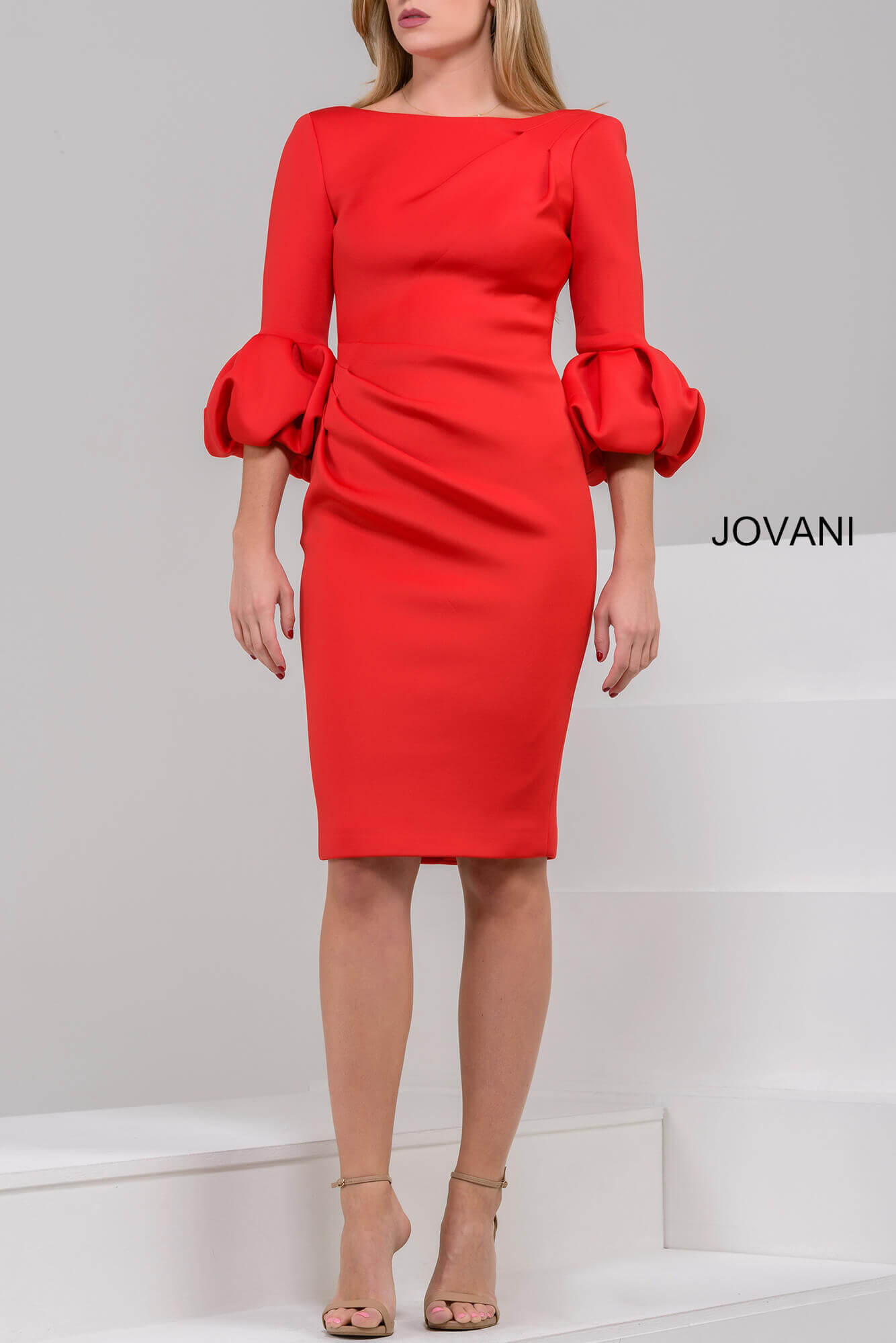 Model wearing Jovani 39738 red dress with elegant puff sleeves and a bateau neckline.