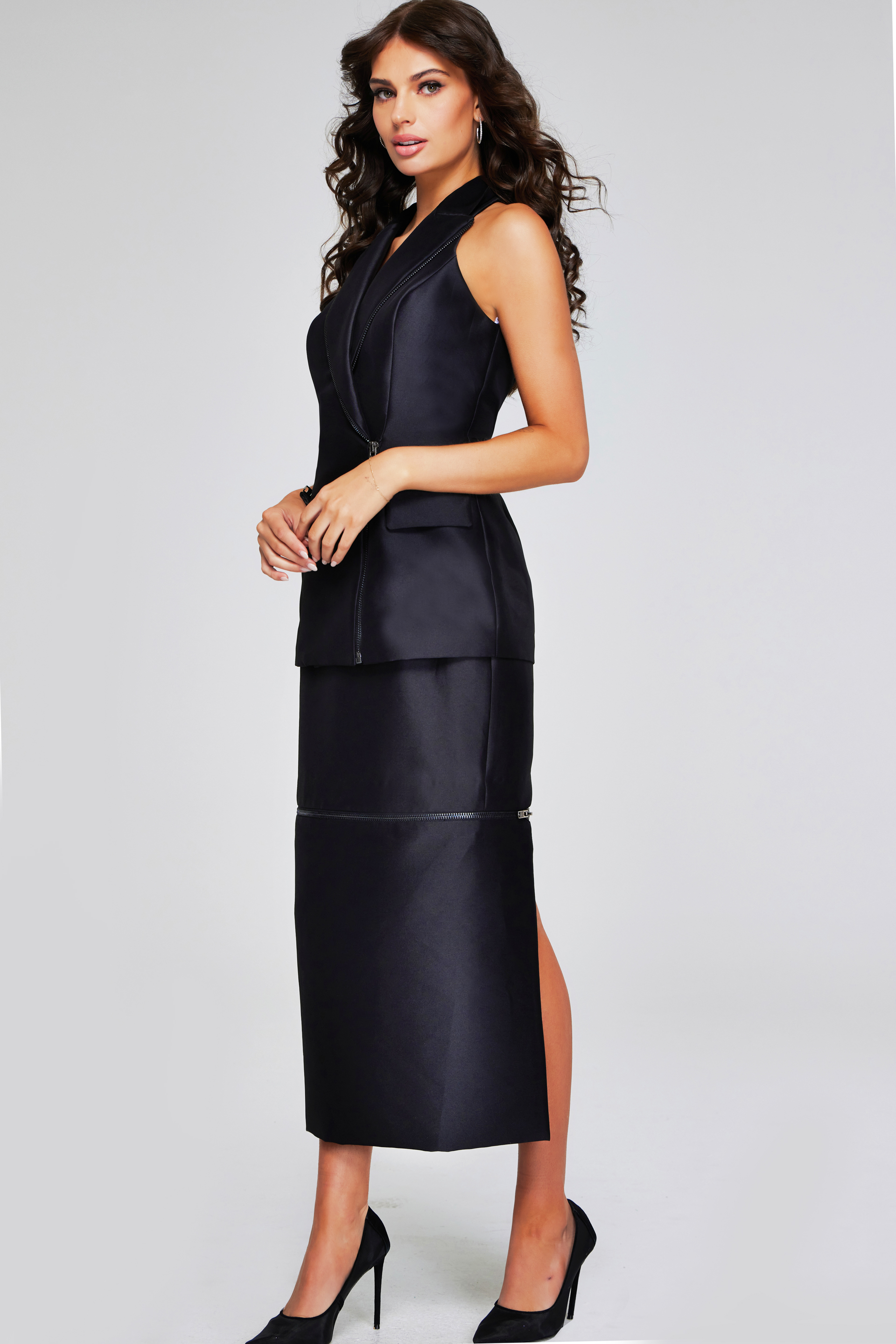 Model wearing Jovani 39801 black sleeveless dress with lapel neckline and side view.
