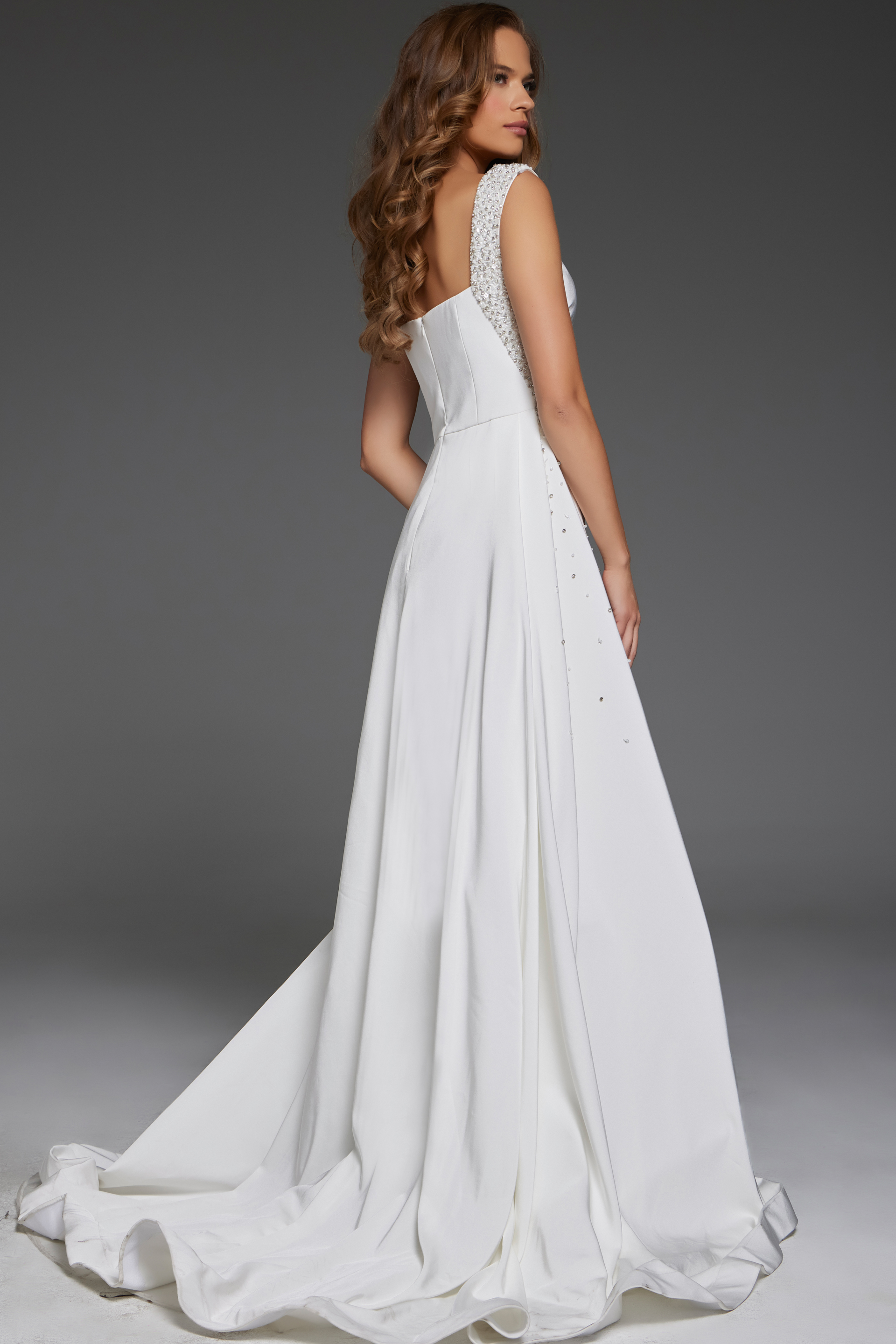 Back view of Jovani 39921 white gown with subtle train and embellished straps