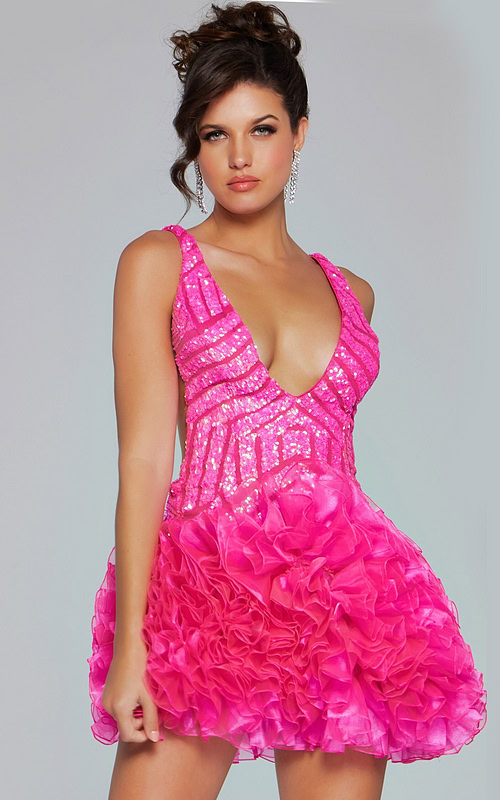 Model wearing Jovani 39931 dress in pink with deep V-neckline and ruffled skirt.