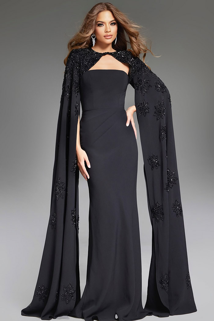 front view of model wearing Jovani 39957 black gown with detailed cape embellishments