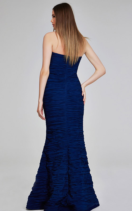 Model wearing Jovani 40045 navy mermaid gown, back view.