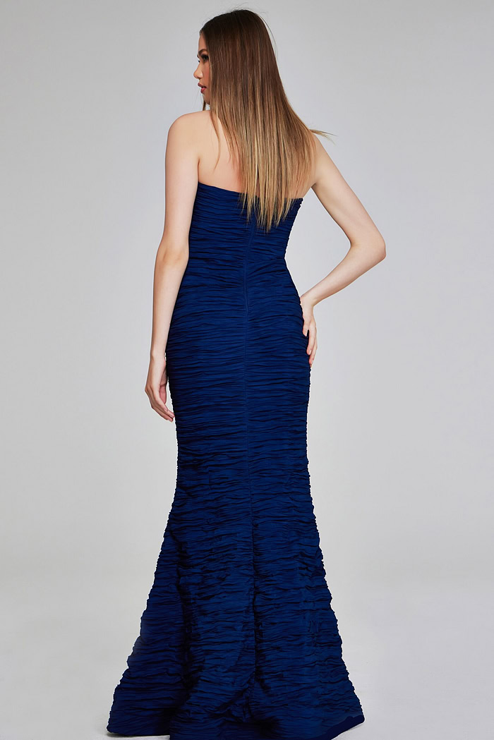 Model wearing Jovani 40045 navy mermaid gown, back view.