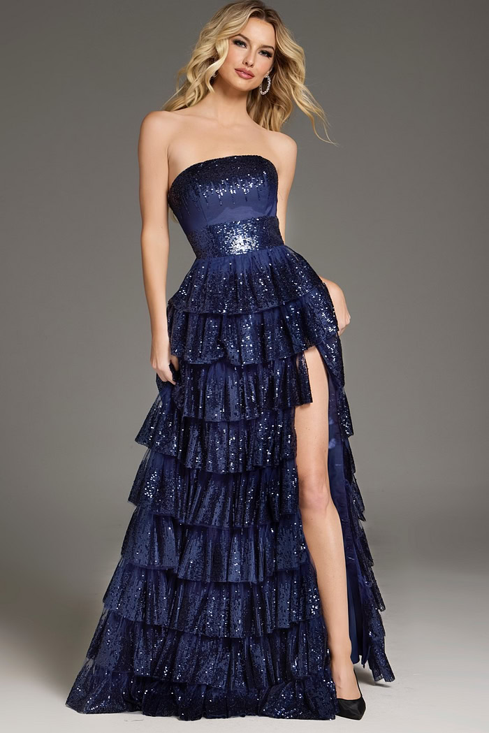 Model showcasing Jovani 40199 navy dress with tiered sequined skirt and high slit, front view.
