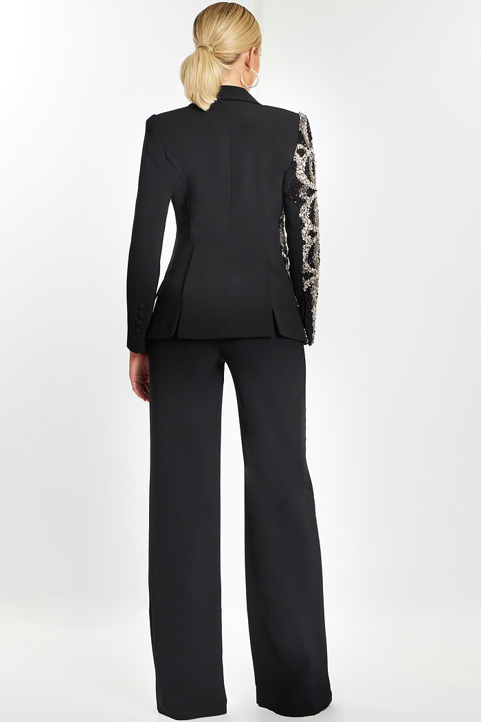 Back view of black formal pantsuit with one sequin-embellished sleeve.