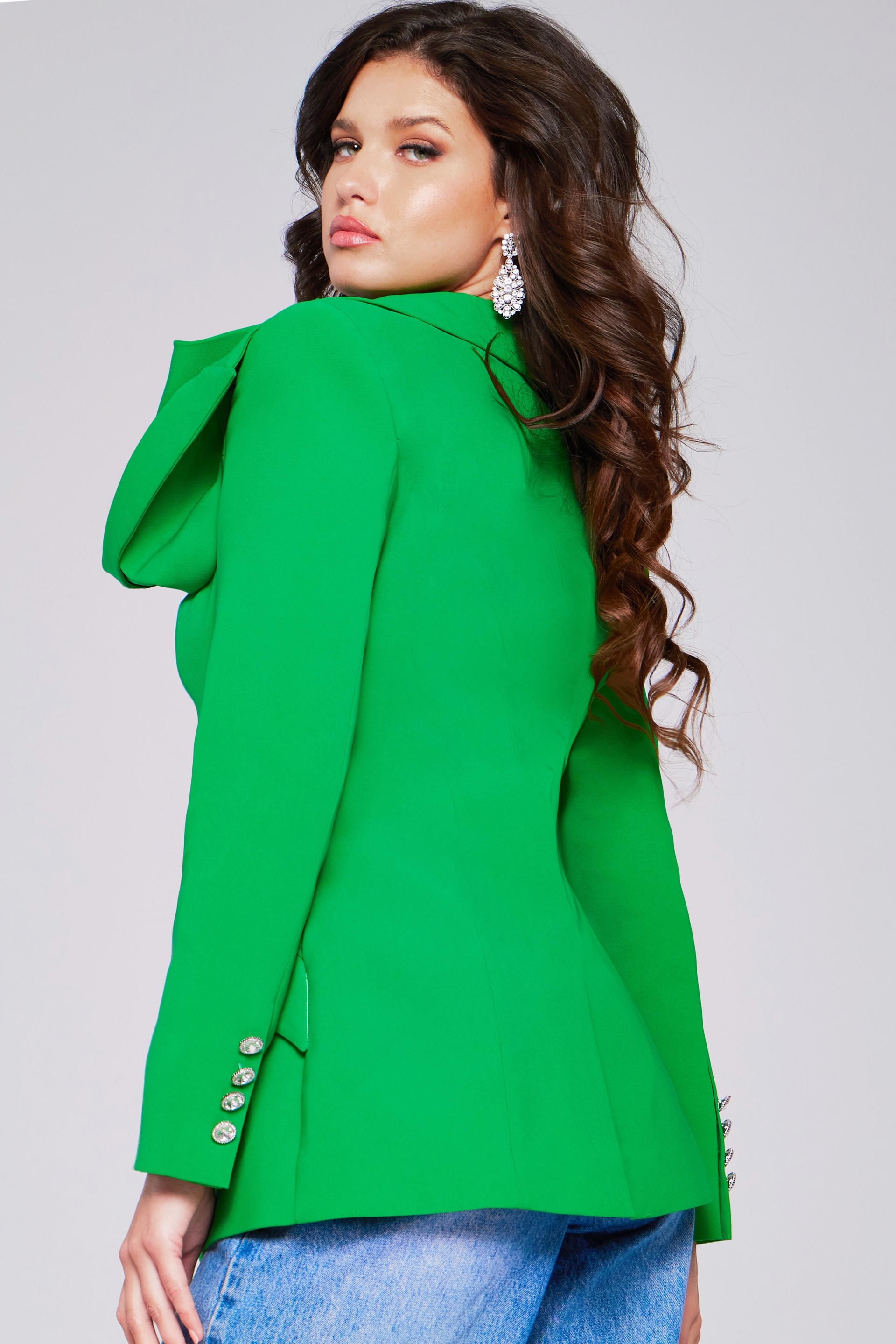 Model wearing Jovani 40283 green blazer with shoulder detail, back perspective