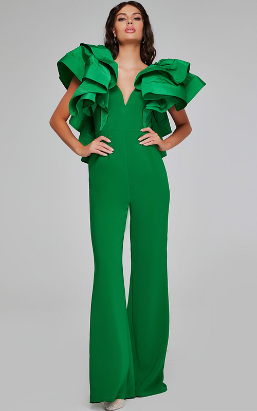 Model wearing Jovani 40291 emerald green jumpsuit featuring a V-neckline and dramatic ruffled sleeves.