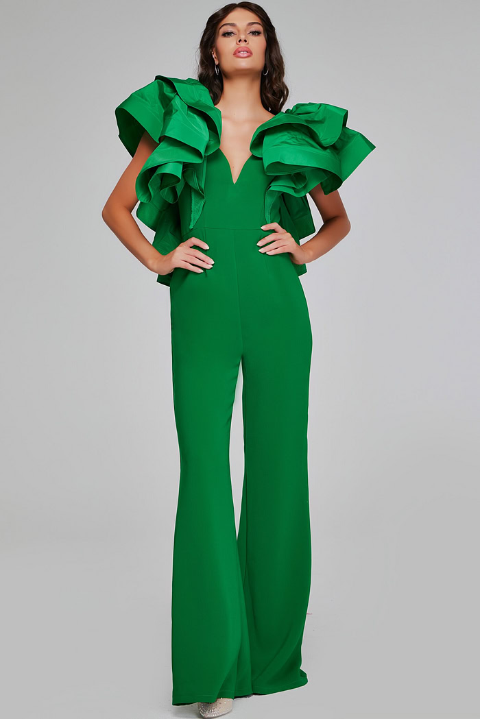 Model wearing Jovani 40291 emerald green jumpsuit featuring a V-neckline and dramatic ruffled sleeves.