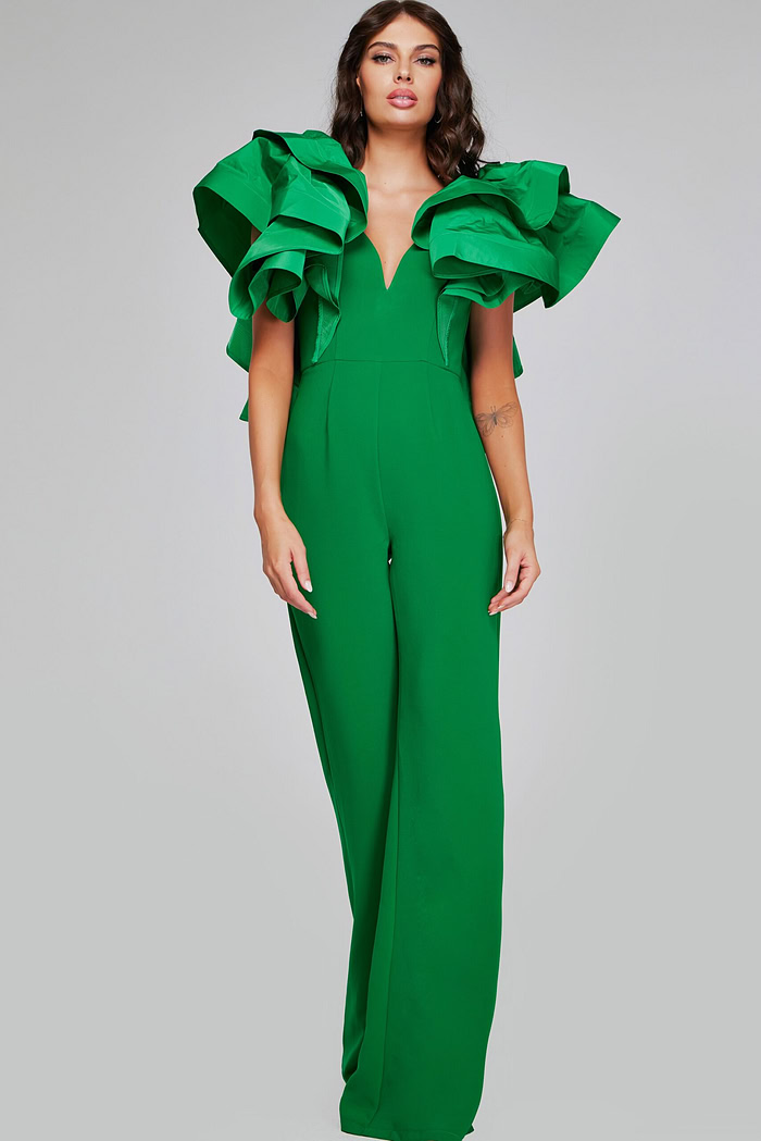 Model wearing Jovani 40291 emerald green jumpsuit with detailed view of the ruffled sleeves.