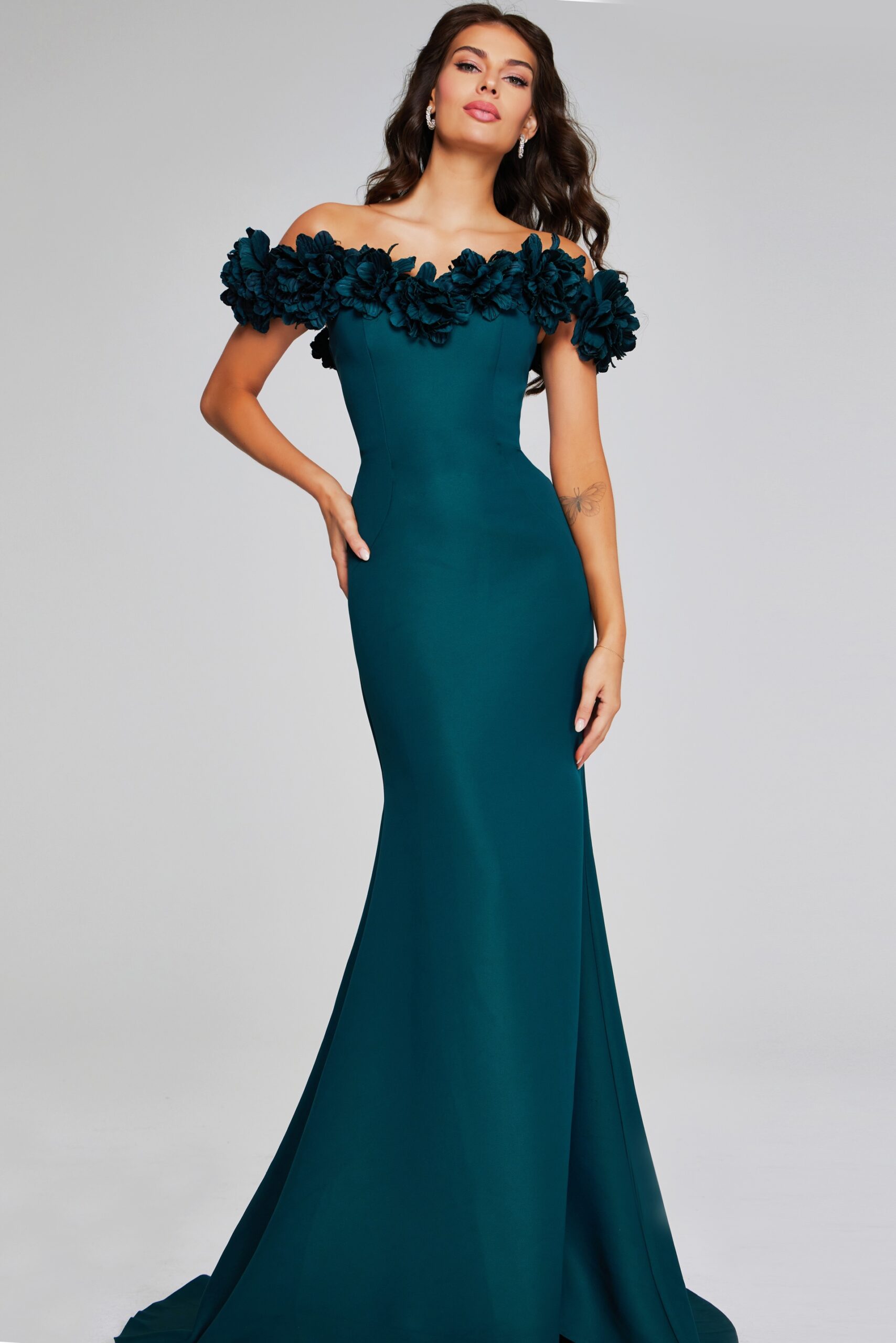 model wearing Jovani 40595 elegant emerald gown with off-the-shoulder floral details