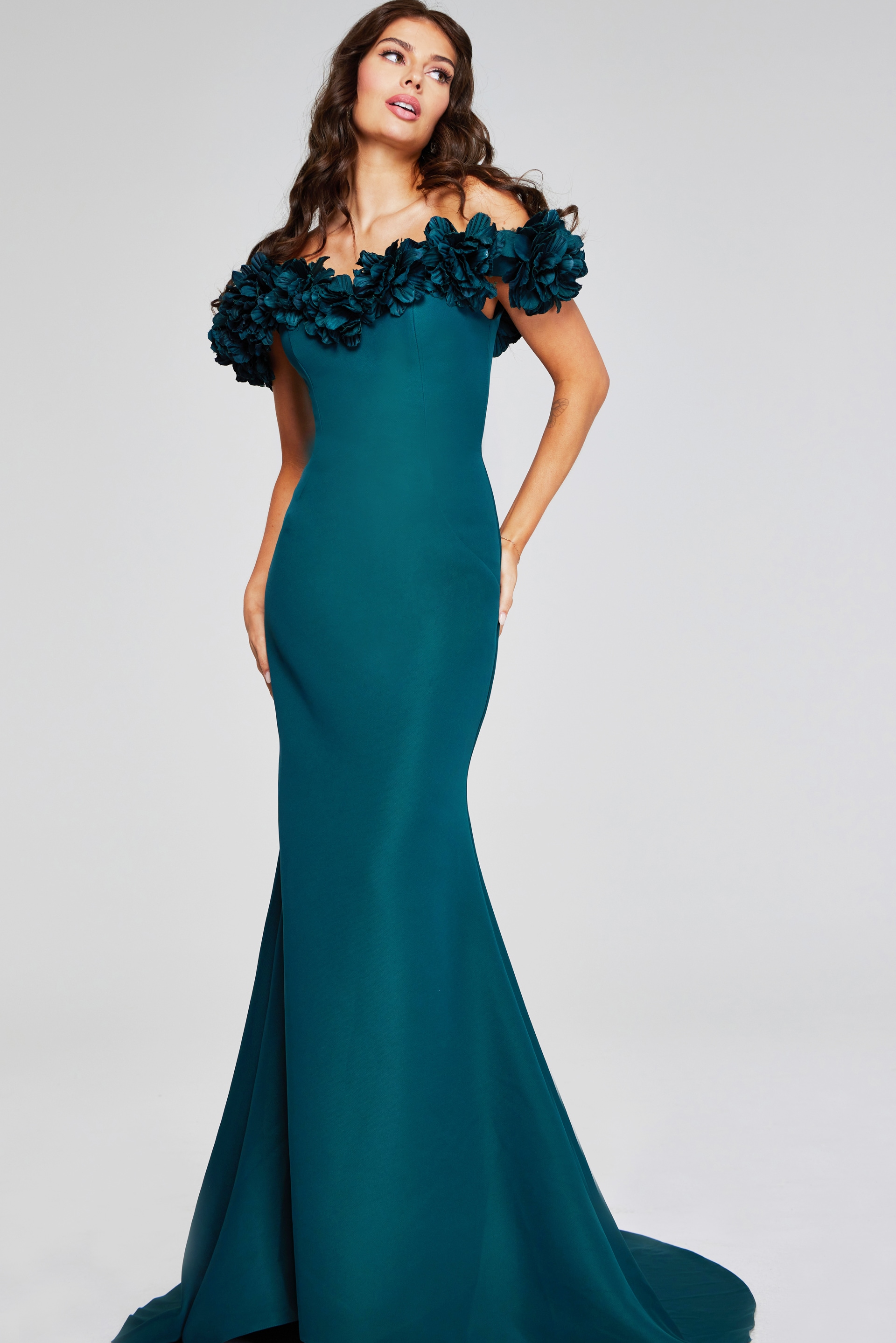 model showcasing Jovani 40595 emerald gown with floral off-the-shoulder design