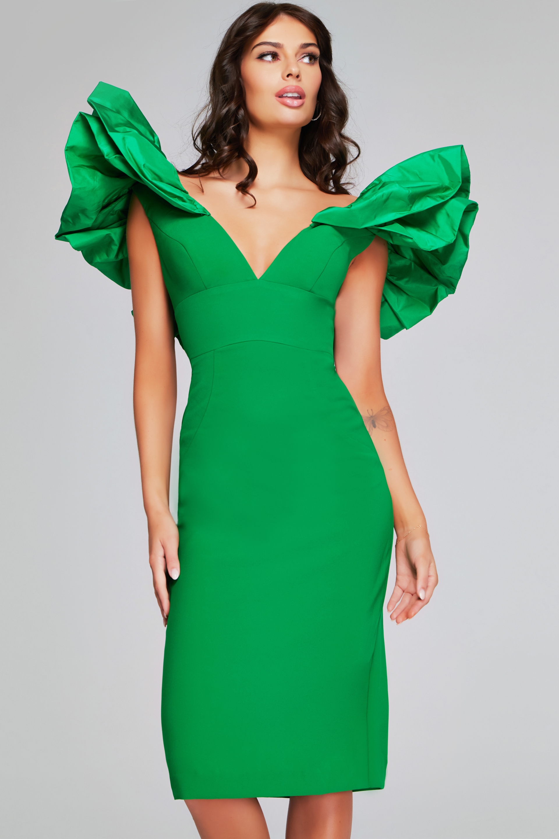 Model wearing Jovani 40662 emerald dress with deep V-neckline and ruffled sleeves, front view