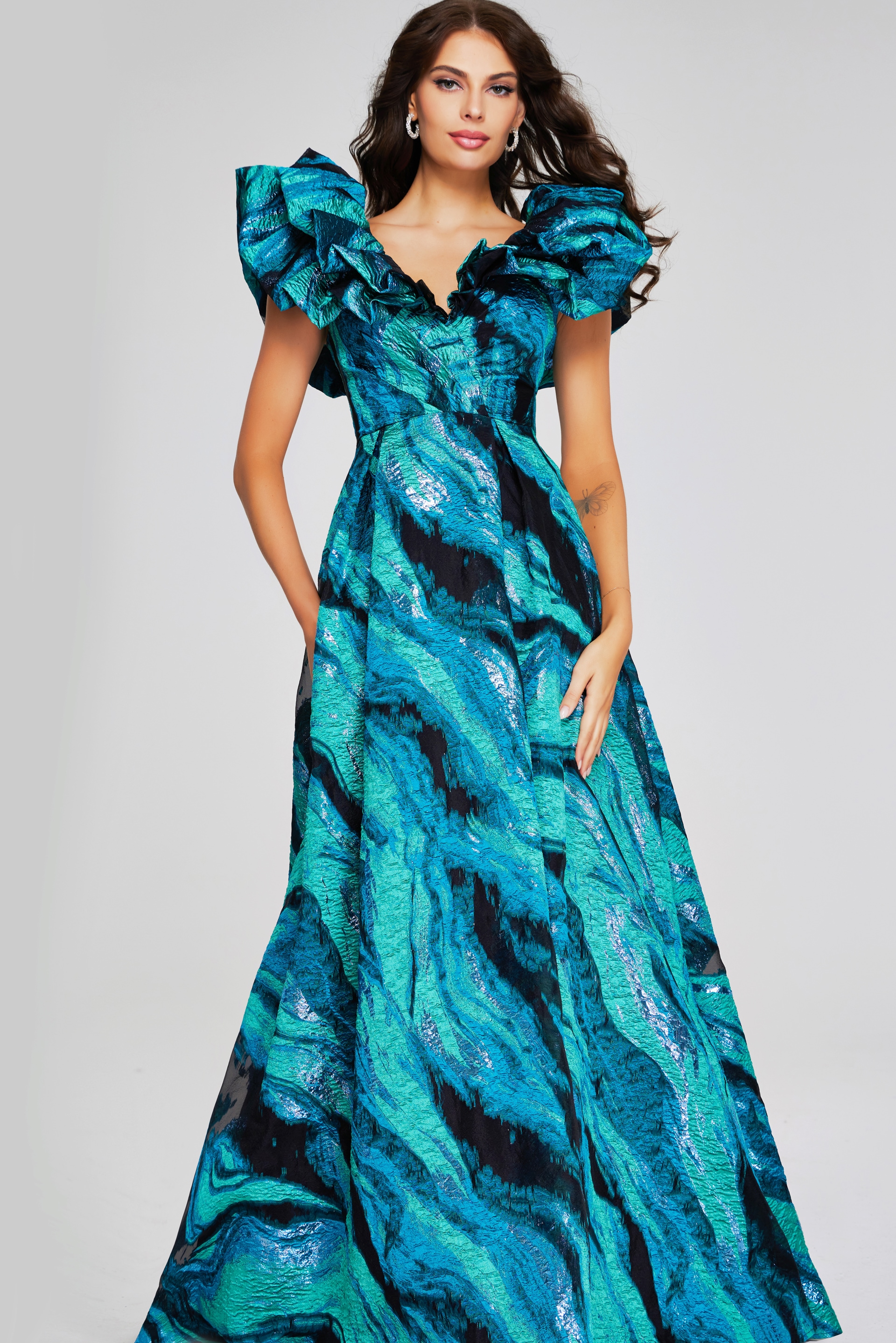 Model wearing Jovani 40696, front view of blue gown with V-neckline.