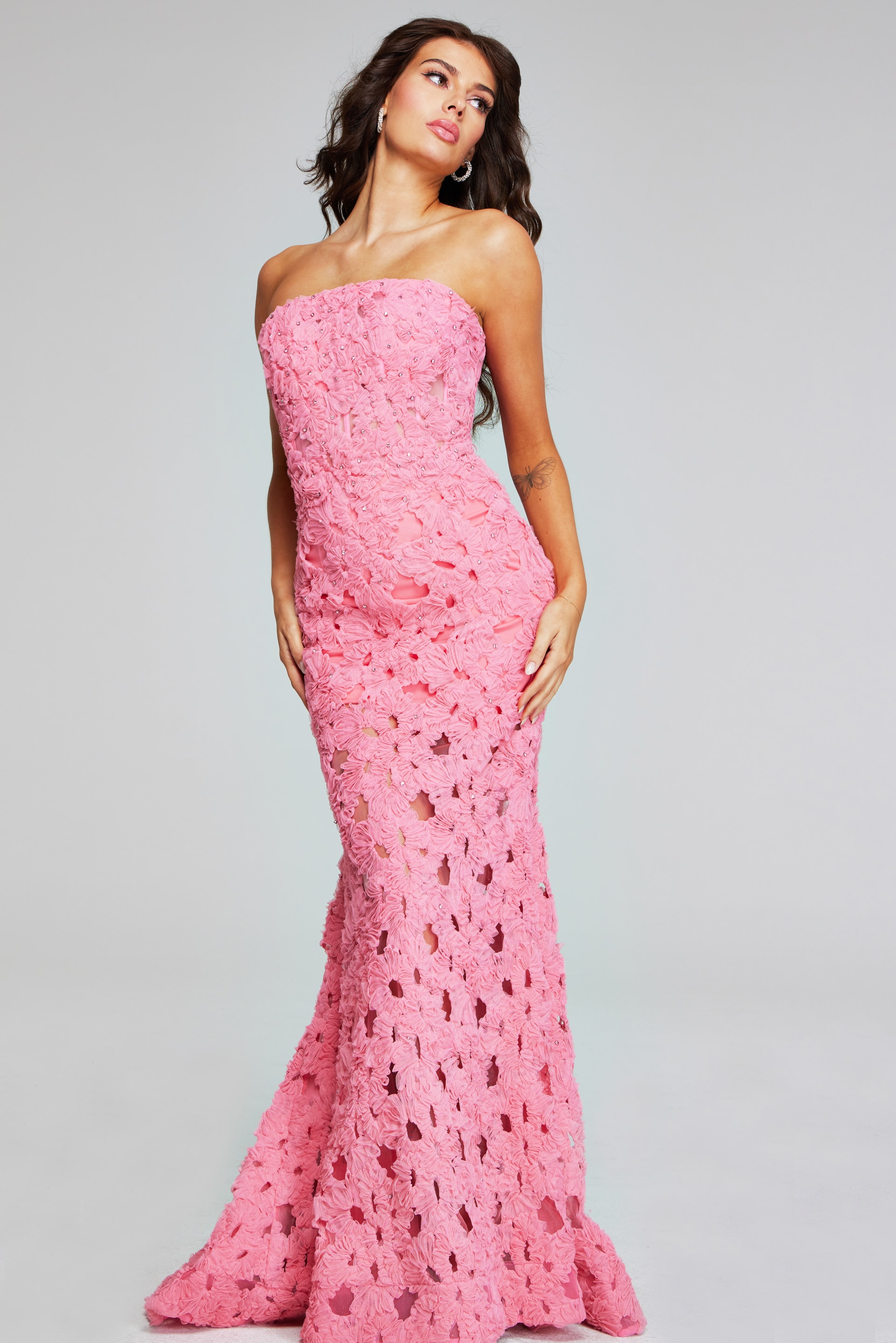 Model posing in Jovani 40744 pink gown with floral applique, front angle.