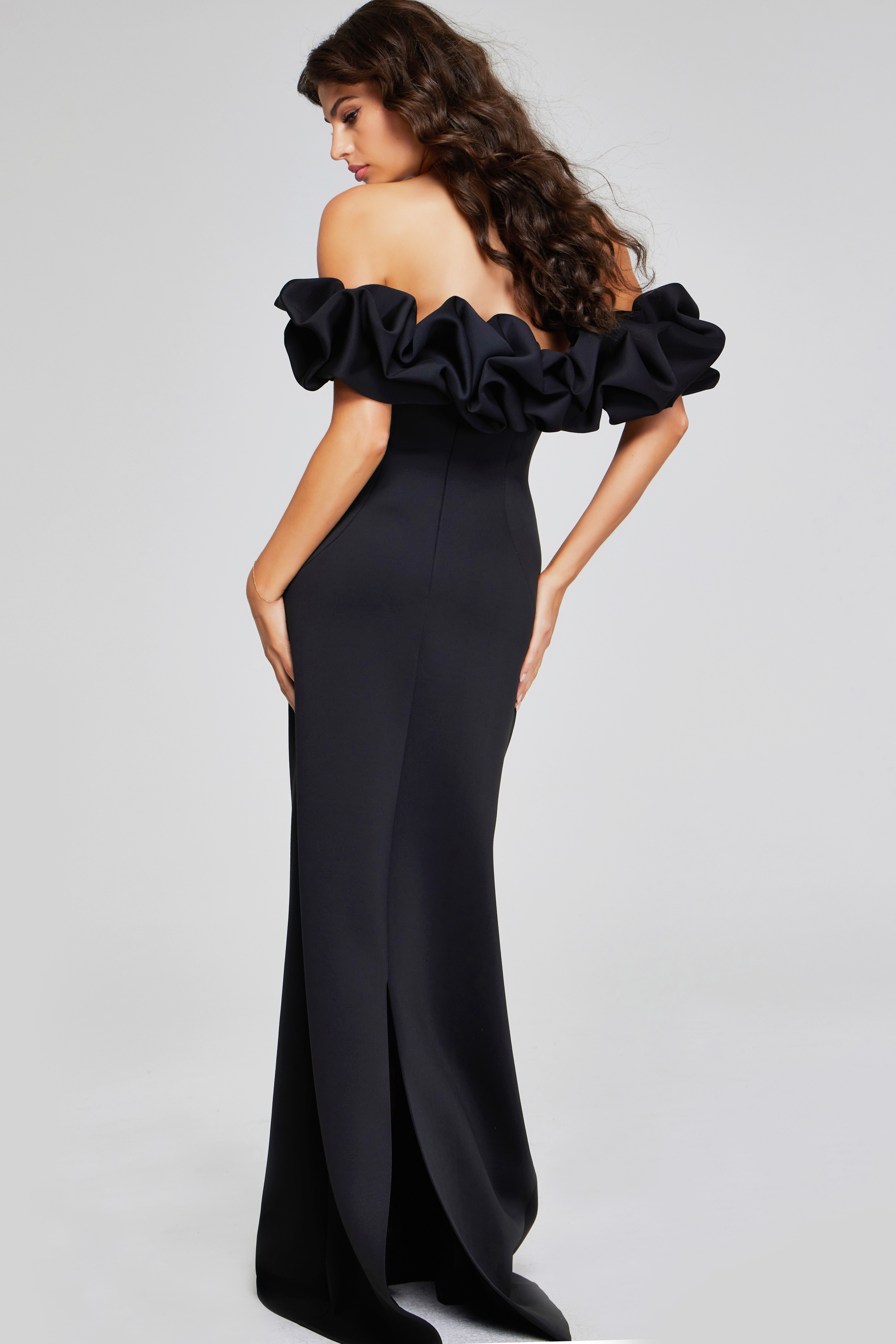 Model wearing Jovani 41084 dress showing back view with ruffled sleeves.