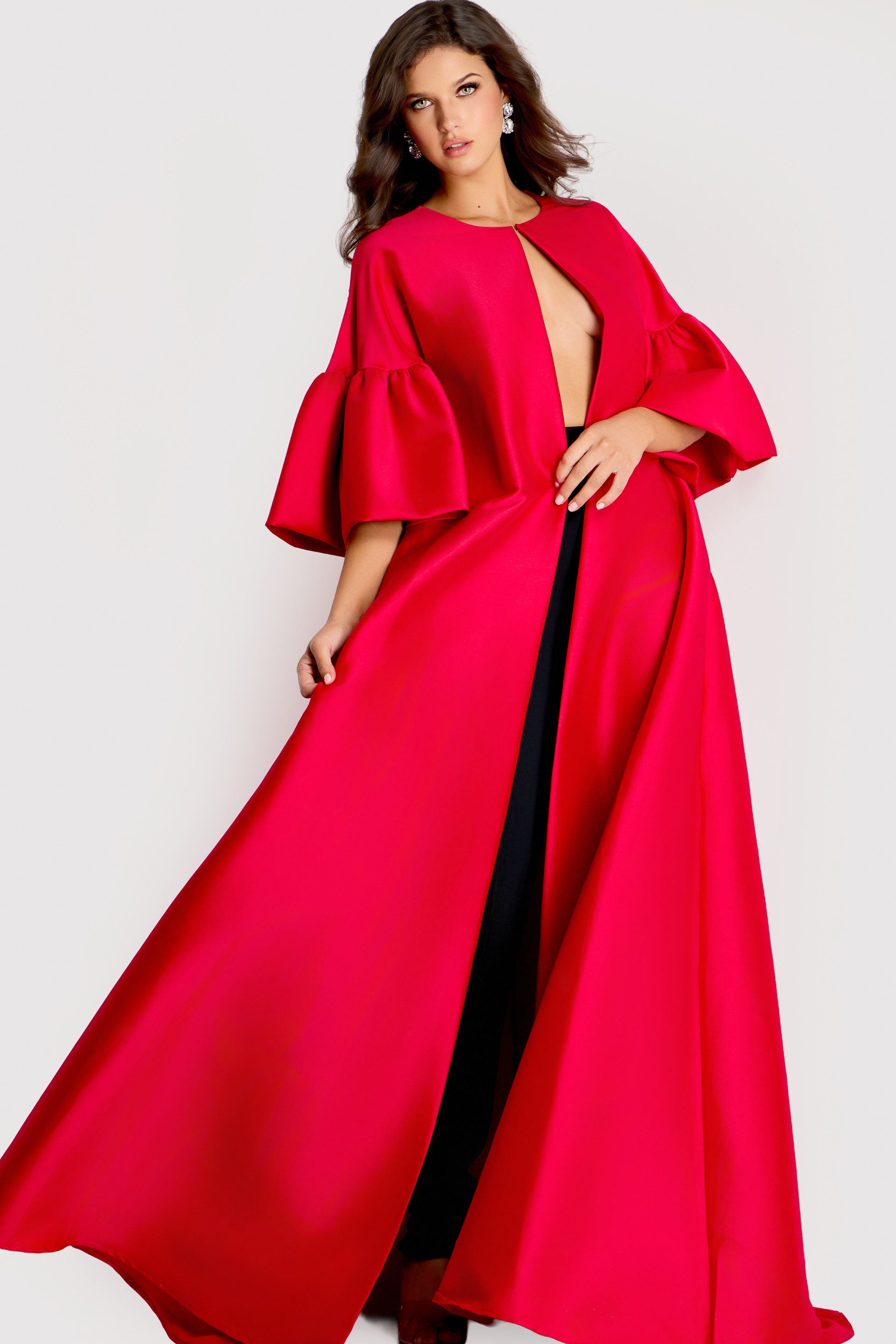 Dramatic floor-length cape with flared sleeves and open front, styled in bold satin fabric for a statement look.